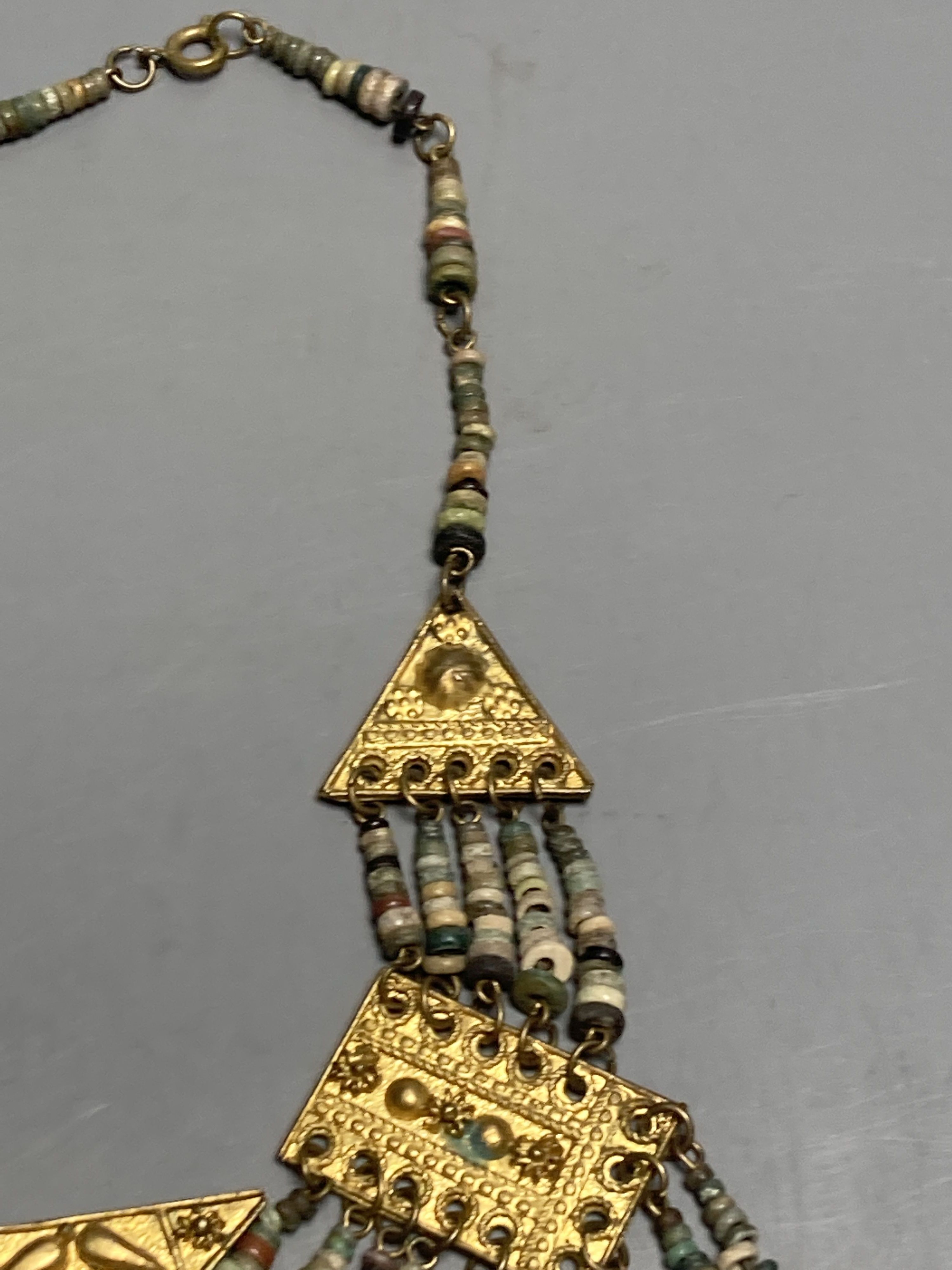 An antique Mayan? gilt metal and hardstone set drop necklace, 42cm.